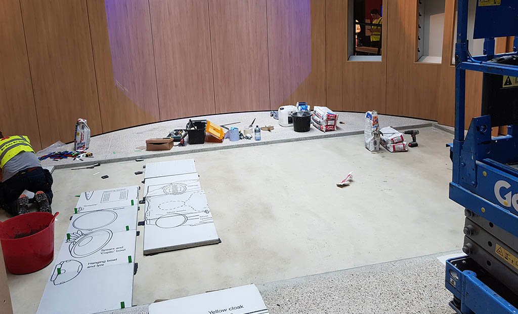 early stage of the installation of graphic COncrete anglo saxon burial chamber floor tiles