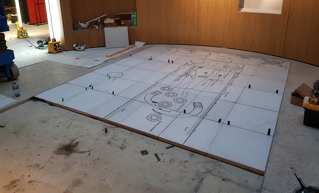 Mid stage of the installation of graphic COncrete anglo saxon burial chamber floor tiles